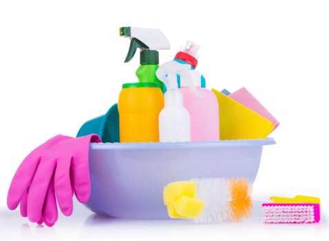 Professional cleaner treating fabric stains on upholstered chair